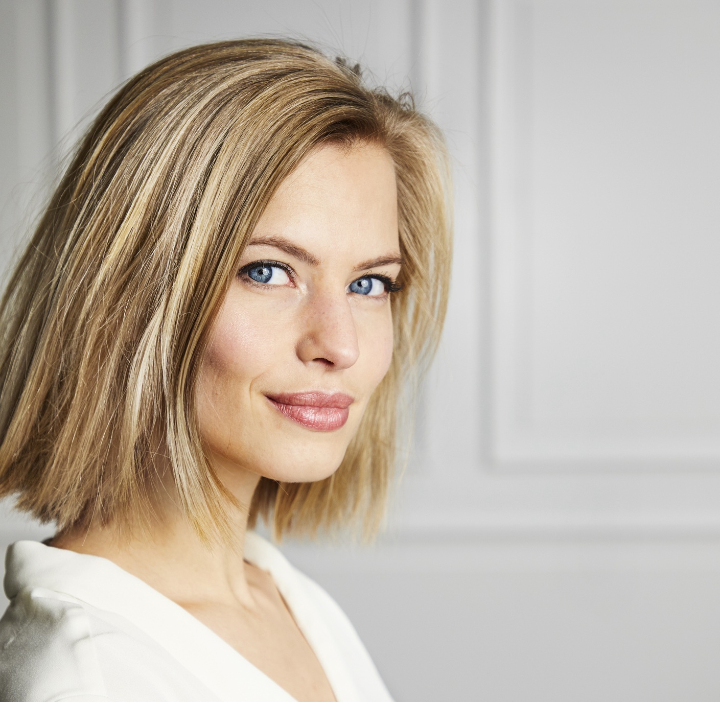 Attraktive, dunkelblonde Frau, zufrieden, nach einer Gesichtsbehandlung.